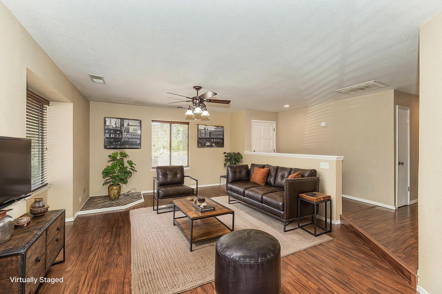 41371 Butte Way Madera, CA 93636 - Photo 46 of 84 a living room with furniture a flat screen tv and wooden floor