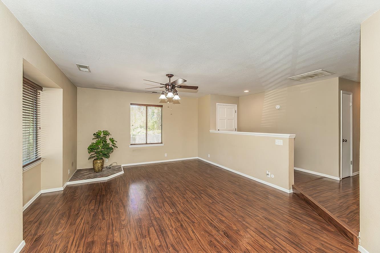 41371 Butte Way Madera, CA 93636 - Photo 47 of 84 a view of an empty room with wooden floor and a window