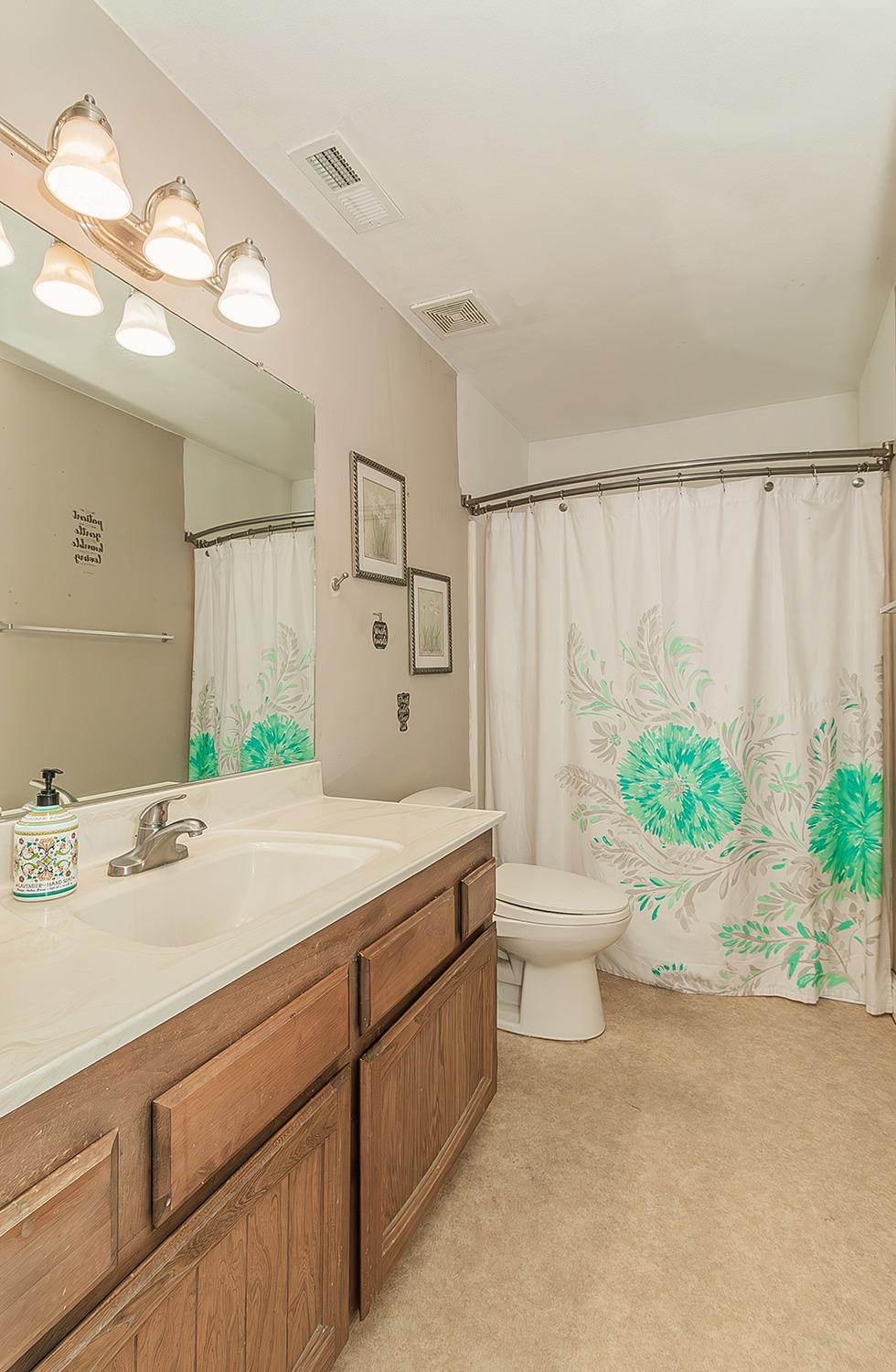 41371 Butte Way Madera, CA 93636 - Photo 58 of 84 a bathroom with a granite countertop sink a toilet and a mirror