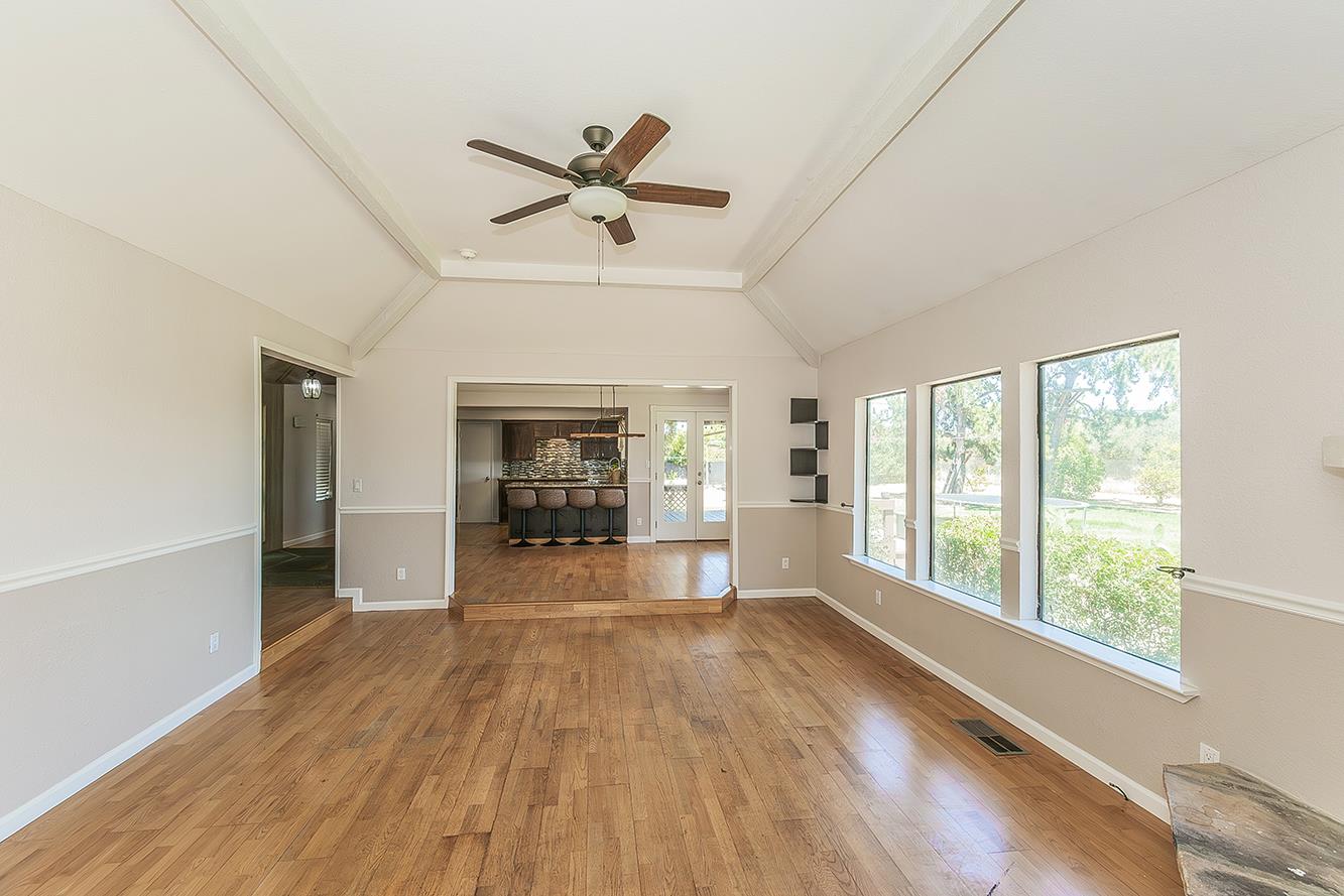 41371 Butte Way Madera, CA 93636 - Photo 9 of 84 a view of empty room with wooden floor and fan