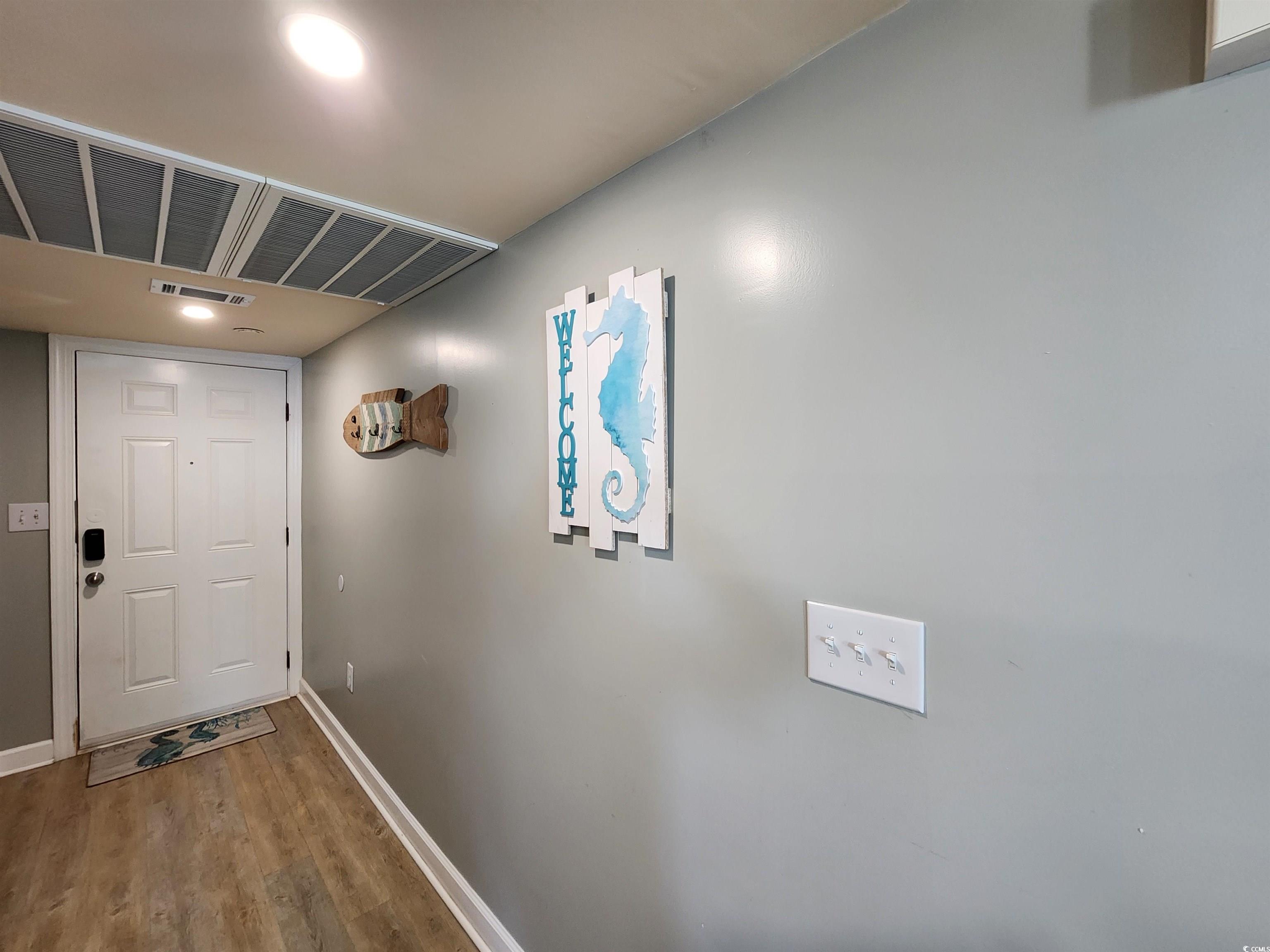 1906 South Ocean Boulevard, Unit 310B Myrtle Beach, SC 29577 - Photo 12 of 34 Doorway to outside featuring wood finished floors