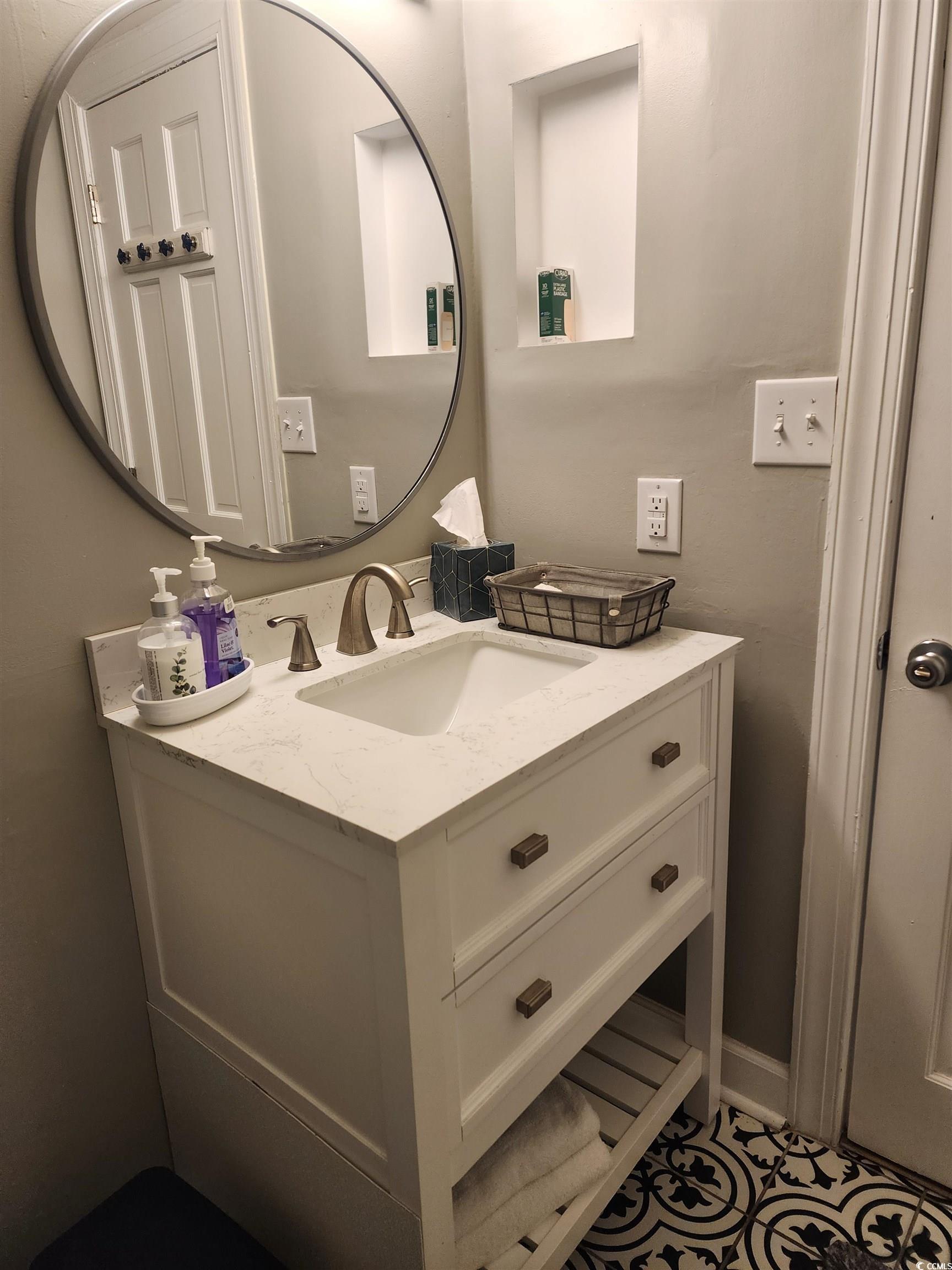 1906 South Ocean Boulevard, Unit 310B Myrtle Beach, SC 29577 - Photo 14 of 34 Bathroom with vanity and tile patterned flooring