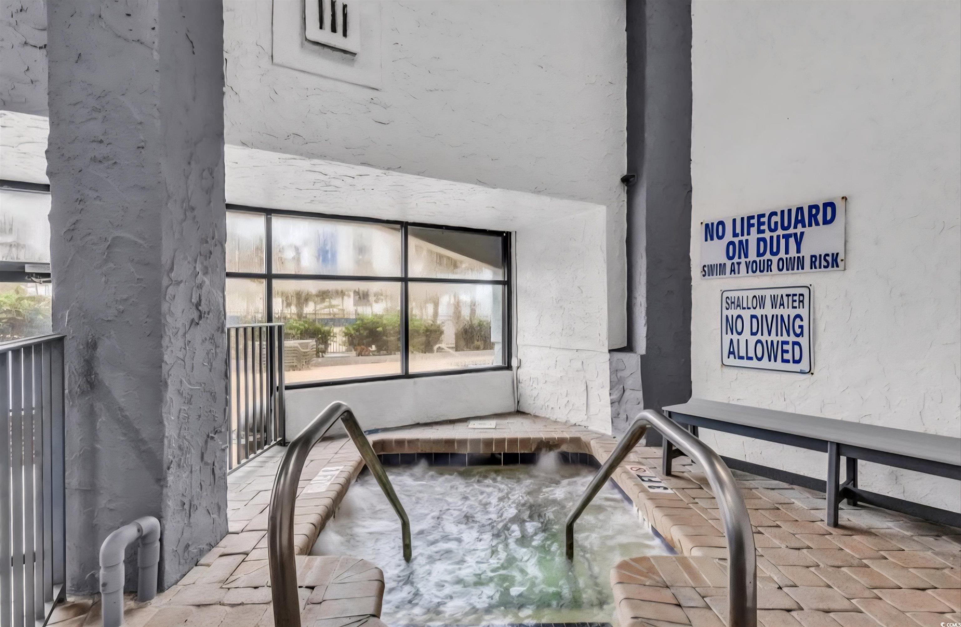 1906 South Ocean Boulevard, Unit 310B Myrtle Beach, SC 29577 - Photo 24 of 34 Exterior space featuring a hot tub and brick floor