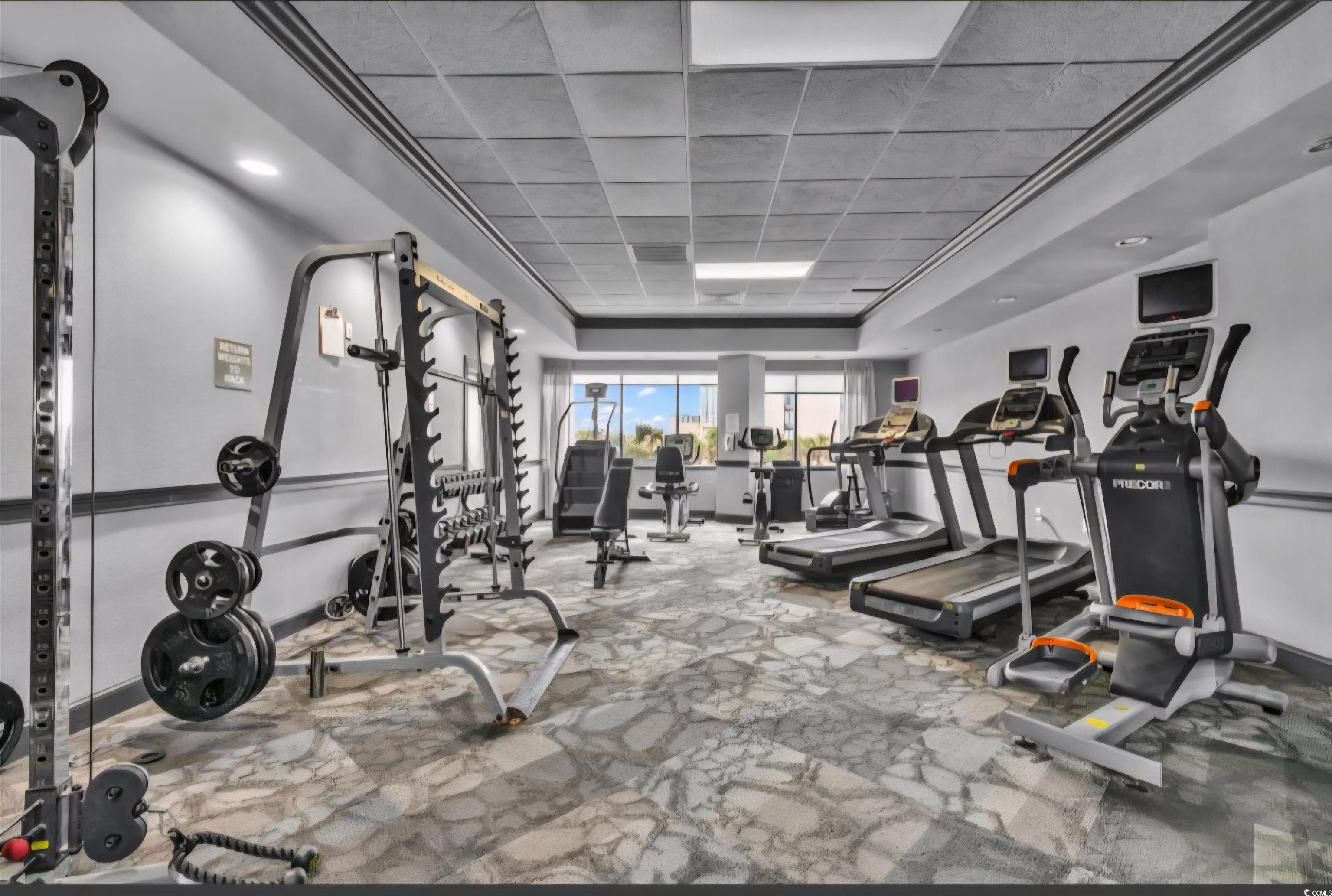 1906 South Ocean Boulevard, Unit 310B Myrtle Beach, SC 29577 - Photo 25 of 34 Workout area with carpet floors, a paneled ceiling