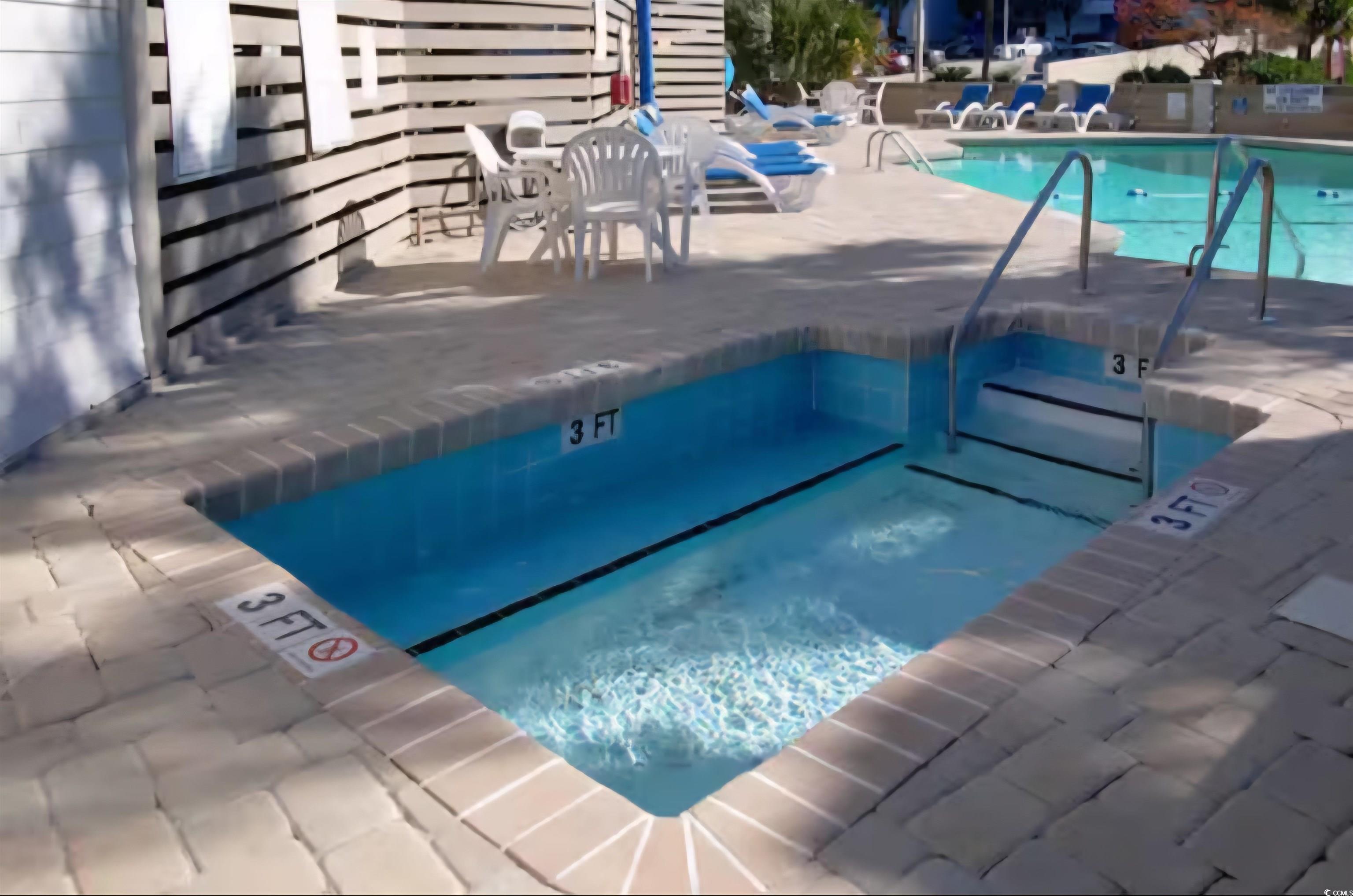 1906 South Ocean Boulevard, Unit 310B Myrtle Beach, SC 29577 - Photo 27 of 34 Community pool with a hot tub and a patio area