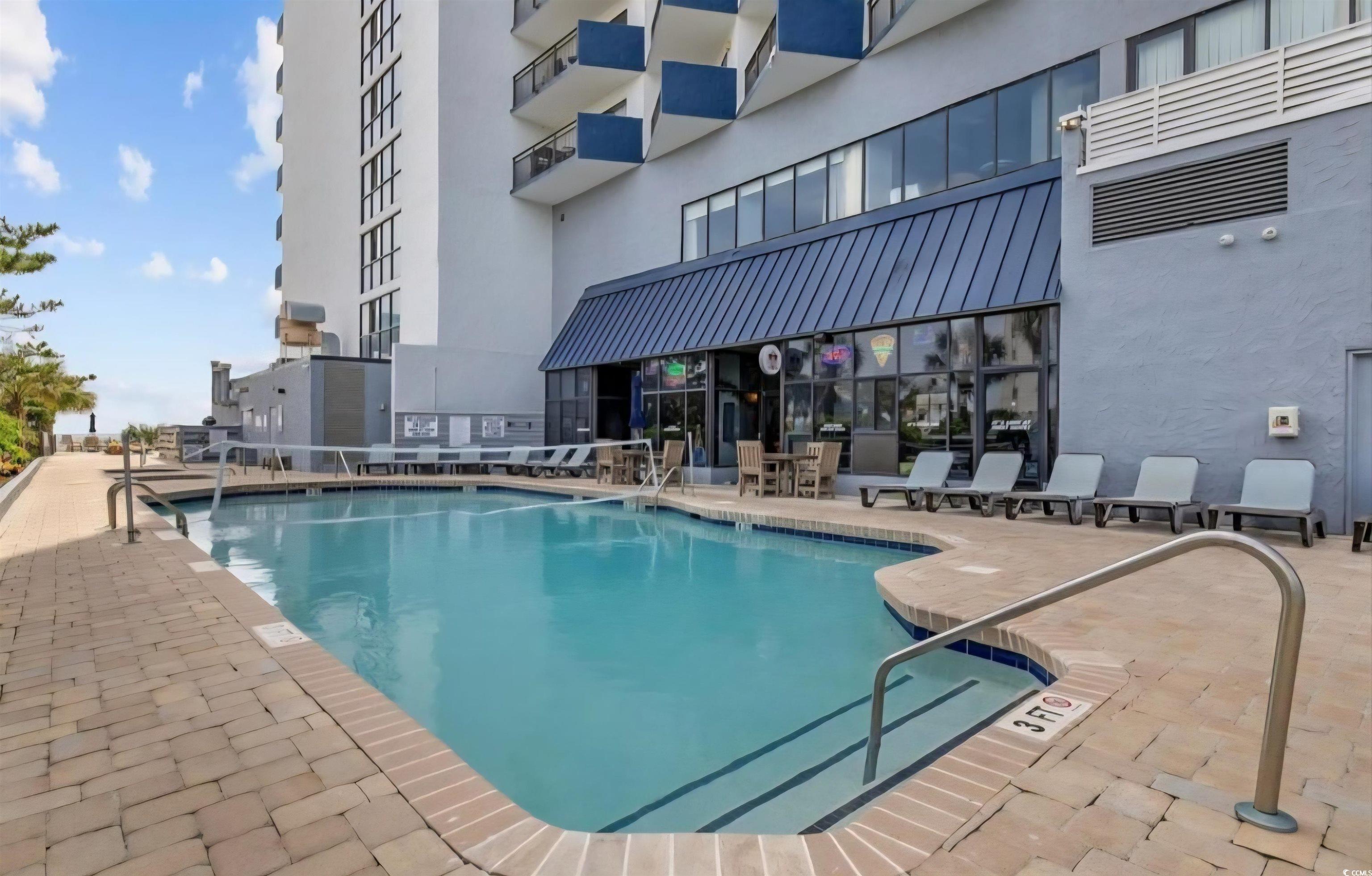 1906 South Ocean Boulevard, Unit 310B Myrtle Beach, SC 29577 - Photo 28 of 34 Community pool with a patio area