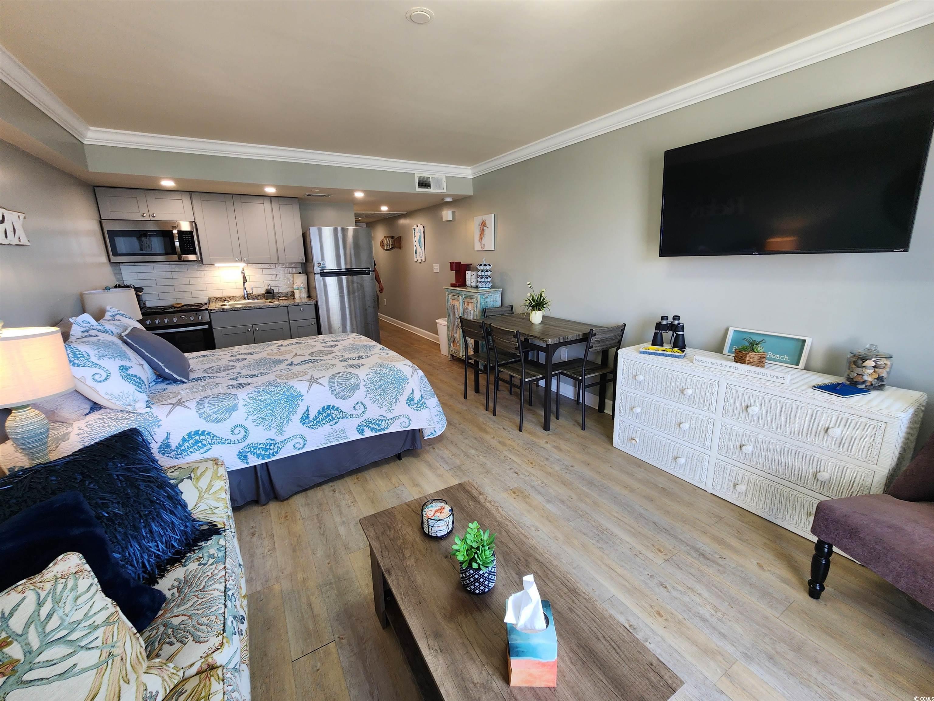 1906 South Ocean Boulevard, Unit 310B Myrtle Beach, SC 29577 - Photo 4 of 34 Bedroom with ornamental molding, freestanding refr