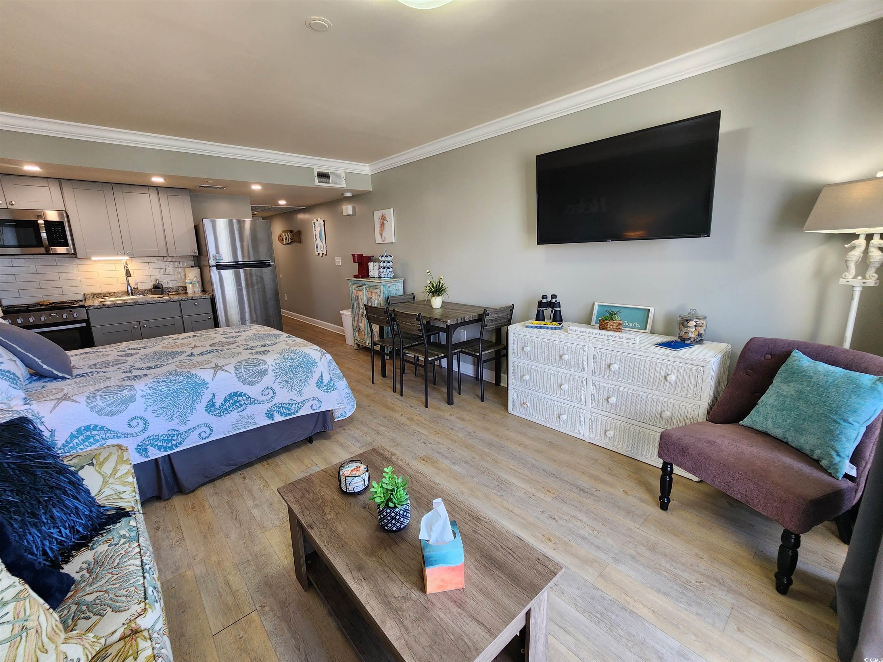 1906 South Ocean Boulevard, Unit 310B Myrtle Beach, SC 29577 - Photo 5 of 34 Bedroom with crown molding, freestanding refrigera