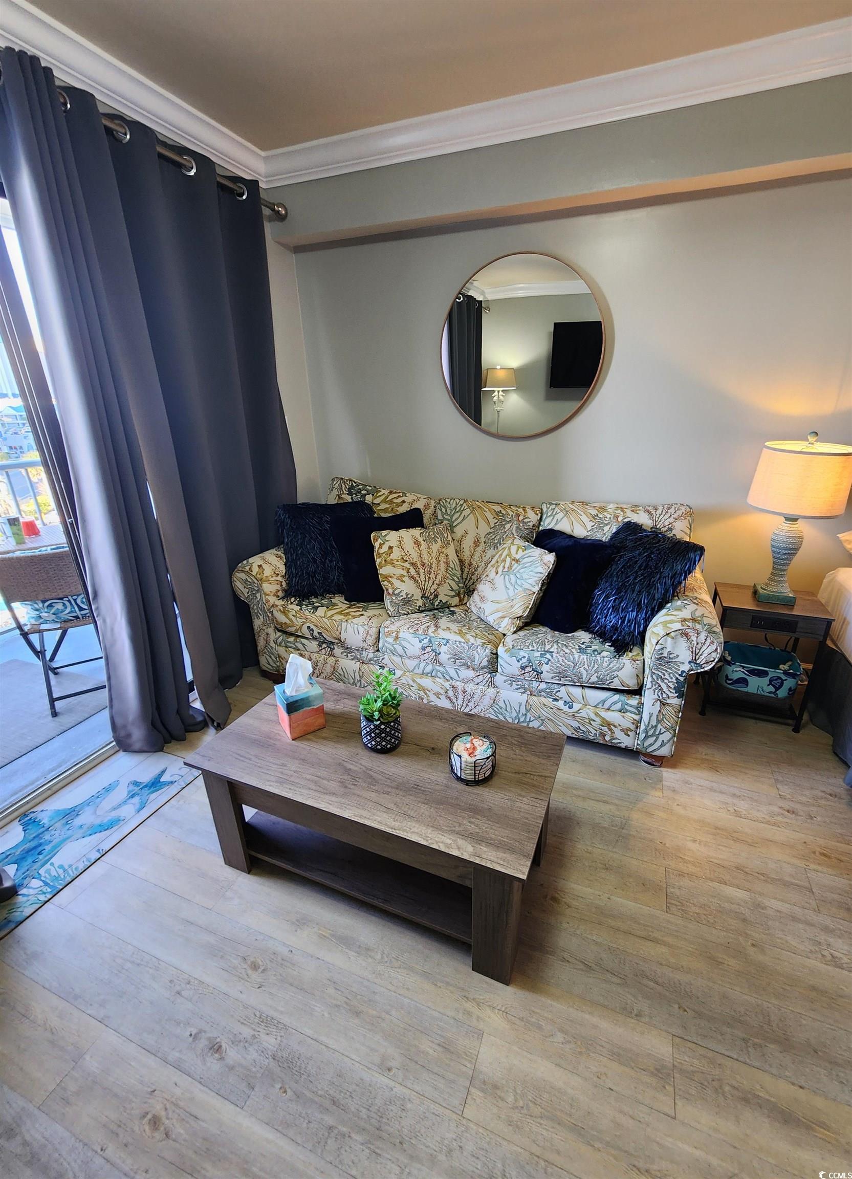 1906 South Ocean Boulevard, Unit 310B Myrtle Beach, SC 29577 - Photo 7 of 34 Living room featuring ornamental molding and light