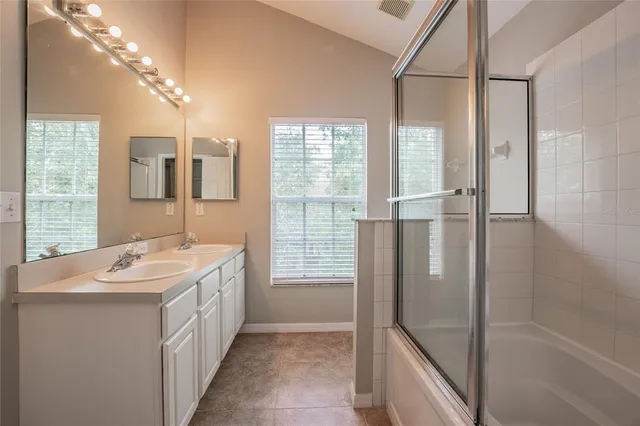 a bathroom with a tub sink and mirror