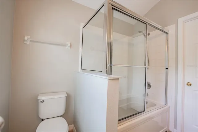 a bathroom that has a toilet and a shower