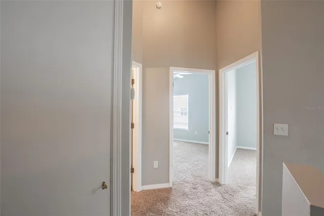 a view of a hallway with a bathroom
