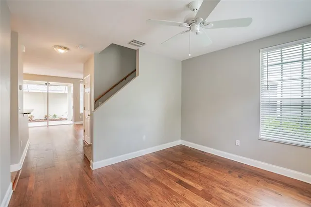 wooden floor in an empty room with a window