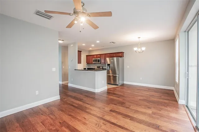 a view of kitchen with refrigerator microwave and stove
