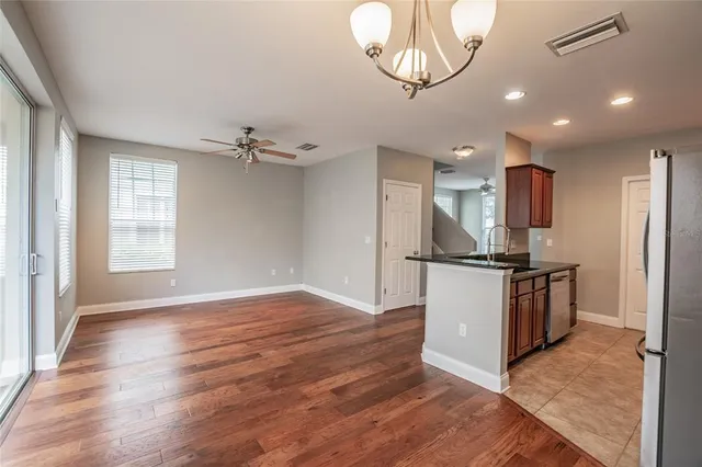 a kitchen with stainless steel appliances granite countertop a refrigerator and a stove top oven