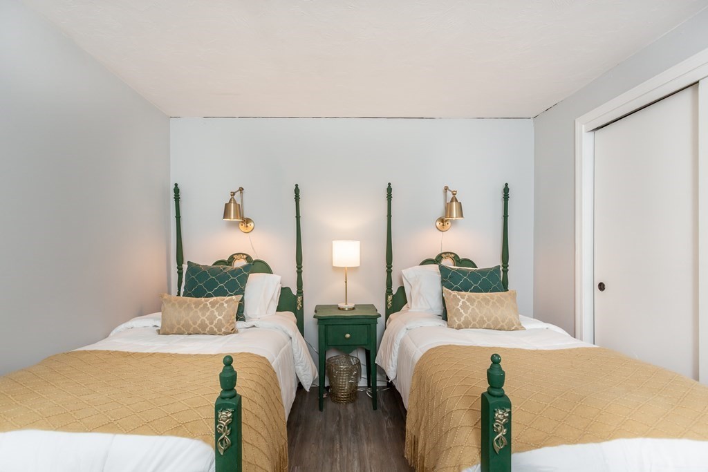 9 Village Way, Unit F Norton, MA 02766 - Photo 12 of 20 a bedroom with a bed and wooden floor