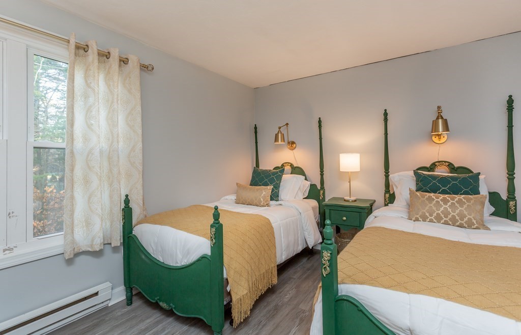 9 Village Way, Unit F Norton, MA 02766 - Photo 13 of 20 a bedroom with a bed and wooden floor