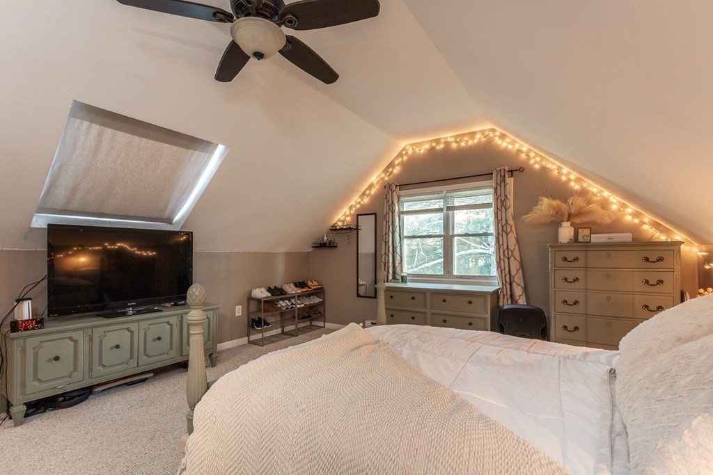 9 Village Way, Unit F Norton, MA 02766 - Photo 16 of 20 a bedroom with a bed and a flat tv screen on the dresser
