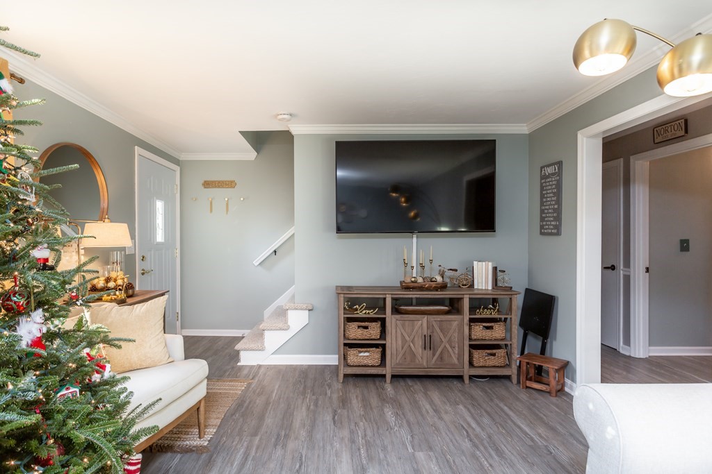 9 Village Way, Unit F Norton, MA 02766 - Photo 3 of 20 a view of a livingroom with furniture and a flat screen tv