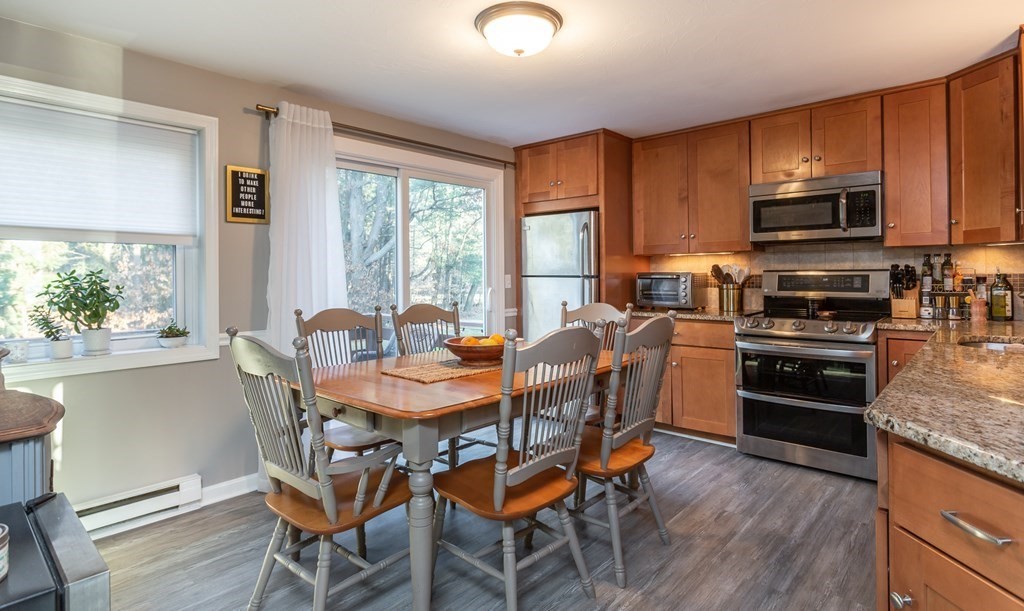 9 Village Way, Unit F Norton, MA 02766 - Photo 6 of 20 a view of a dining room with furniture window and wooden floor