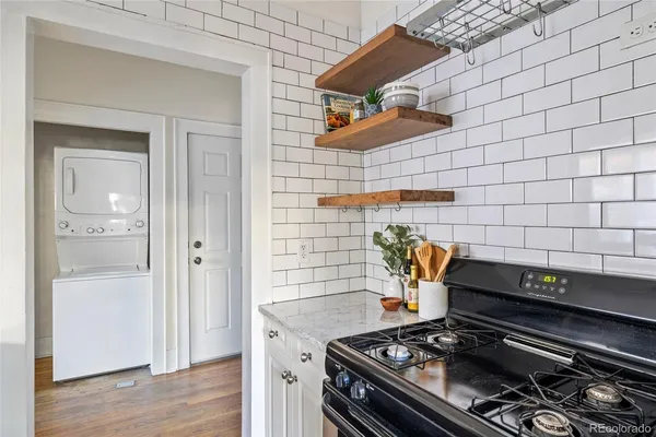 a kitchen with stainless steel appliances granite countertop a refrigerator and a stove