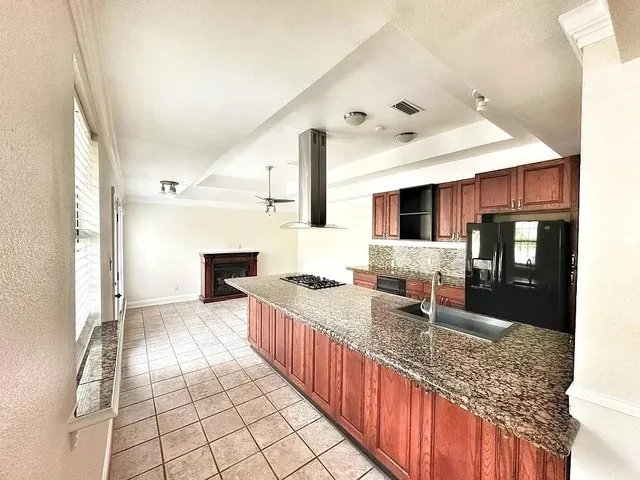 a spacious bathroom with a granite countertop sink and a large mirror