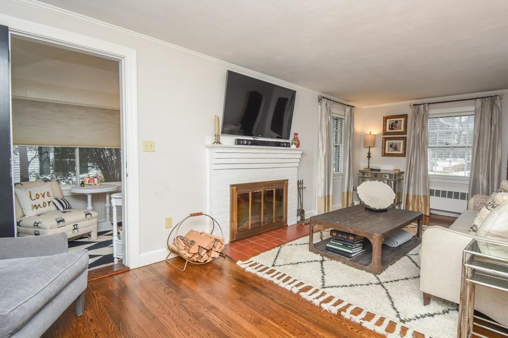 21 Lancaster Road Needham, MA 02492 - Photo 15 of 35 a living room with furniture and a fireplace