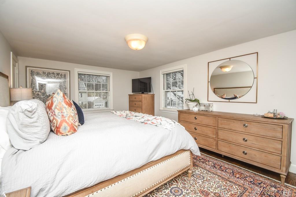 21 Lancaster Road Needham, MA 02492 - Photo 20 of 35 a bedroom with a large bed and a dresser