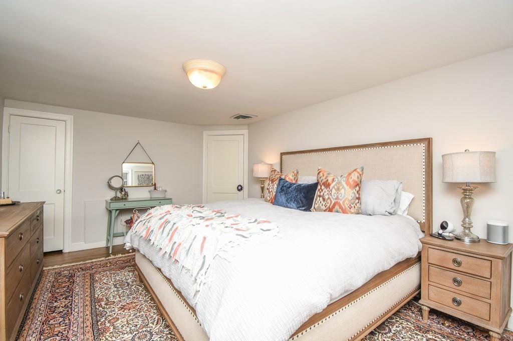 21 Lancaster Road Needham, MA 02492 - Photo 21 of 35 a bed room with a bed and a lamp