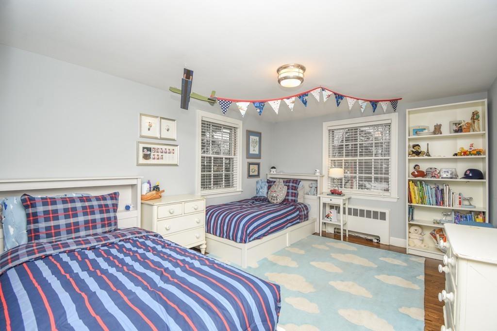 21 Lancaster Road Needham, MA 02492 - Photo 22 of 35 a bedroom with a bed and dresser with wooden floor