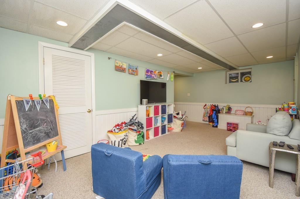 21 Lancaster Road Needham, MA 02492 - Photo 29 of 35 a living room with furniture and a flat screen tv