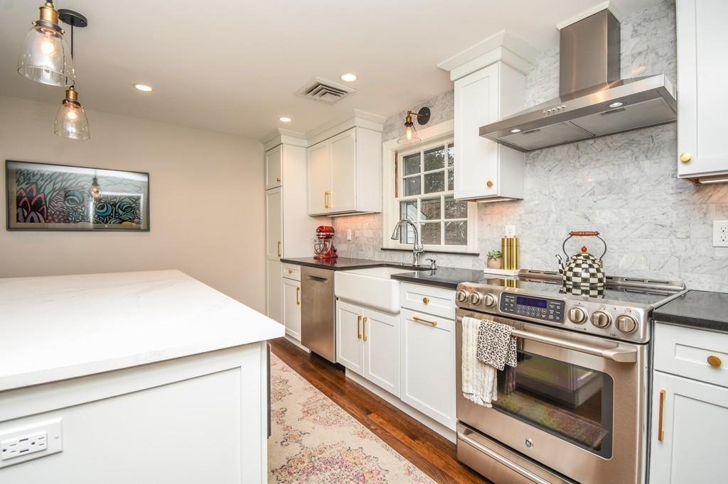 21 Lancaster Road Needham, MA 02492 - Photo 4 of 35 a kitchen with stainless steel appliances a stove a sink and a refrigerator