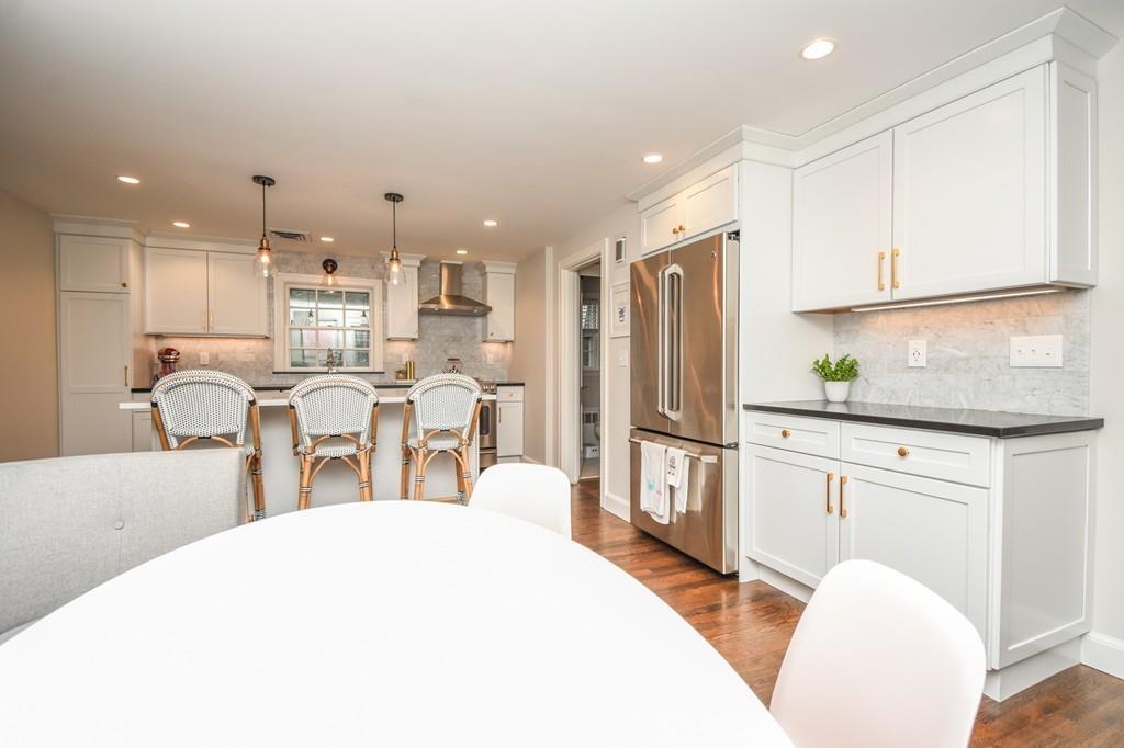21 Lancaster Road Needham, MA 02492 - Photo 7 of 35 a large kitchen with kitchen island a large counter top space a sink stainless steel appliances and cabinets