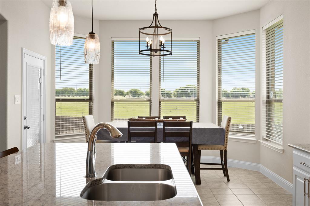 2618 Byrd Ranch Road Midlothian, TX 76065 - Photo 13 of 38 a view of a dining room and livingroom with furniture wooden floor and a chandelier