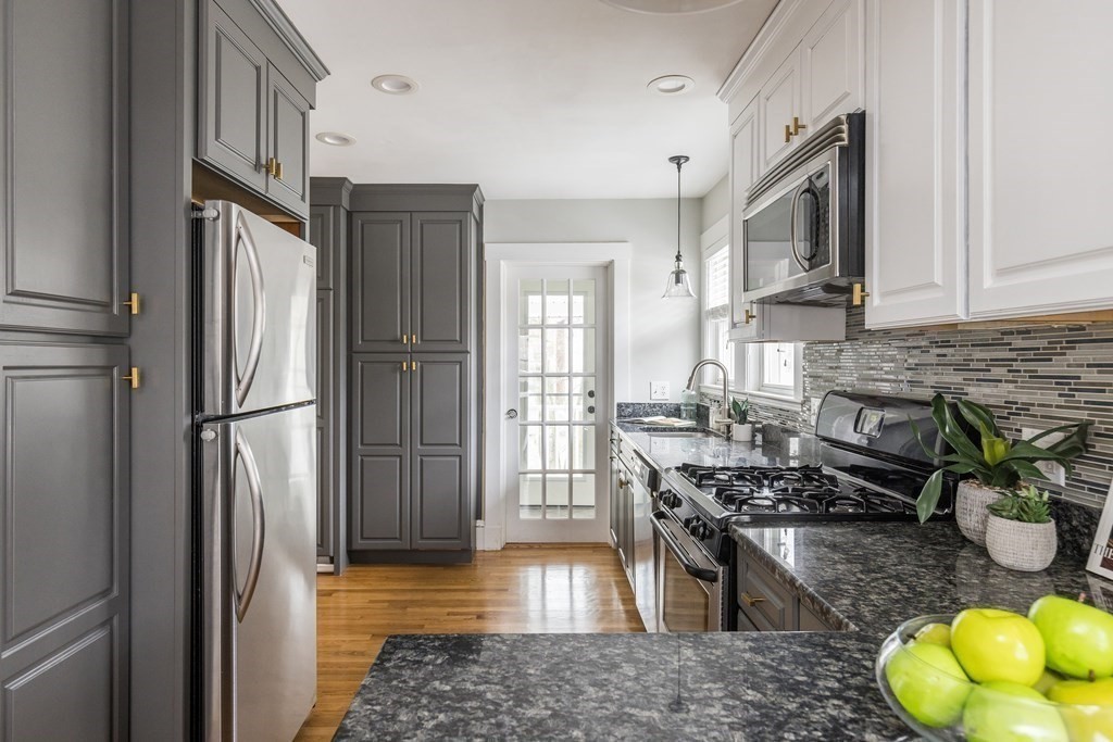 30 Fuller Road, Unit 30 Watertown, MA 02472 - Photo 7 of 24 a kitchen with stainless steel appliances granite countertop a refrigerator a stove a sink and a refrigerator