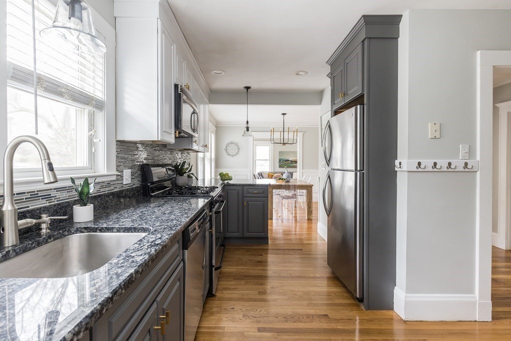 30 Fuller Road, Unit 30 Watertown, MA 02472 - Photo 8 of 24 a kitchen with granite countertop a refrigerator a sink a stove and cabinets