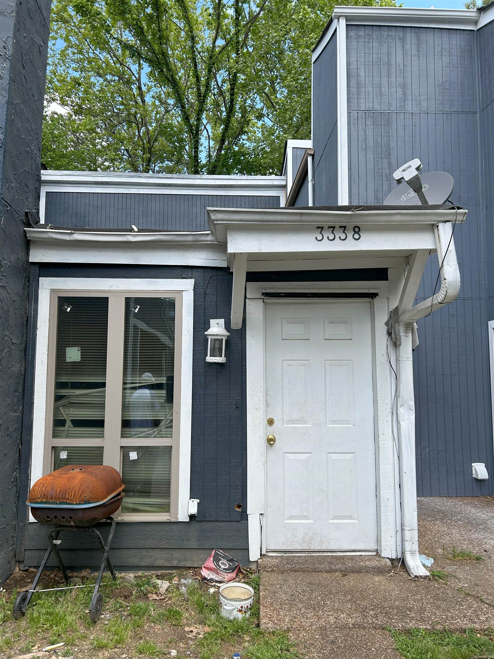 a backyard of a house with barbeque oven