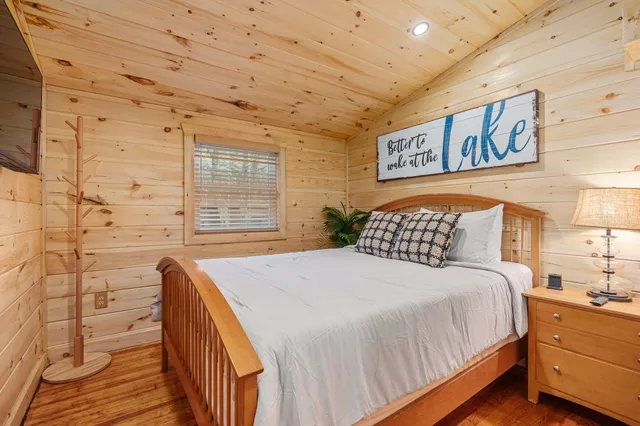 a bedroom with a bed and a flat screen tv
