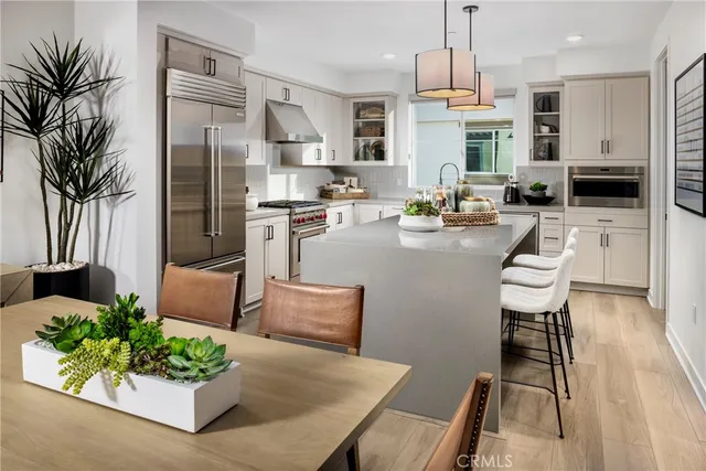a living room with stainless steel appliances kitchen island granite countertop furniture and a fireplace