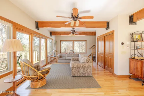 a living room with furniture and a floor to ceiling window
