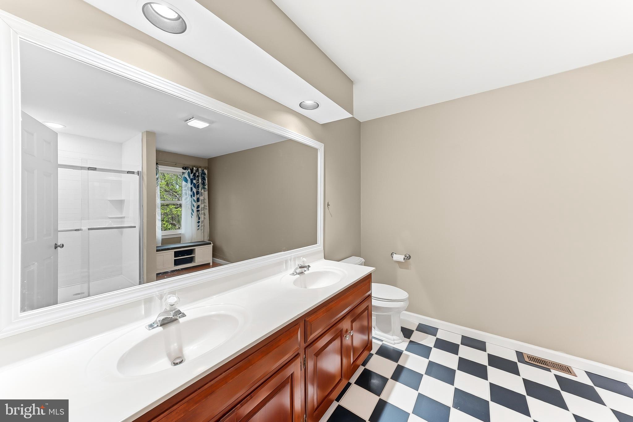 522 Ridge Drive Lincoln University, PA 19352 - Photo 30 of 63 a spacious bathroom with a double vanity sink a mirror and a shower