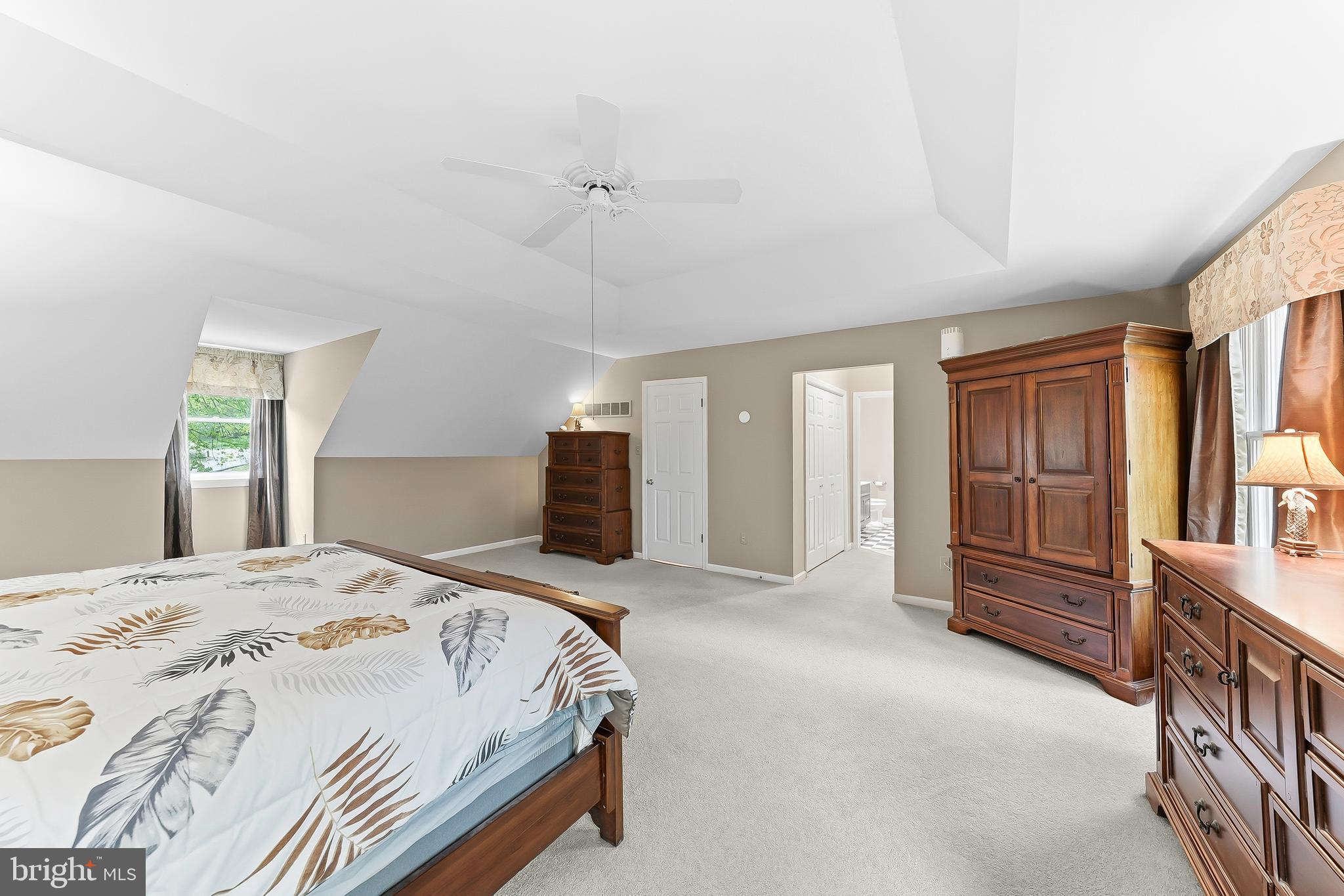 522 Ridge Drive Lincoln University, PA 19352 - Photo 37 of 63 a spacious bedroom with a bed a dresser and cabinets