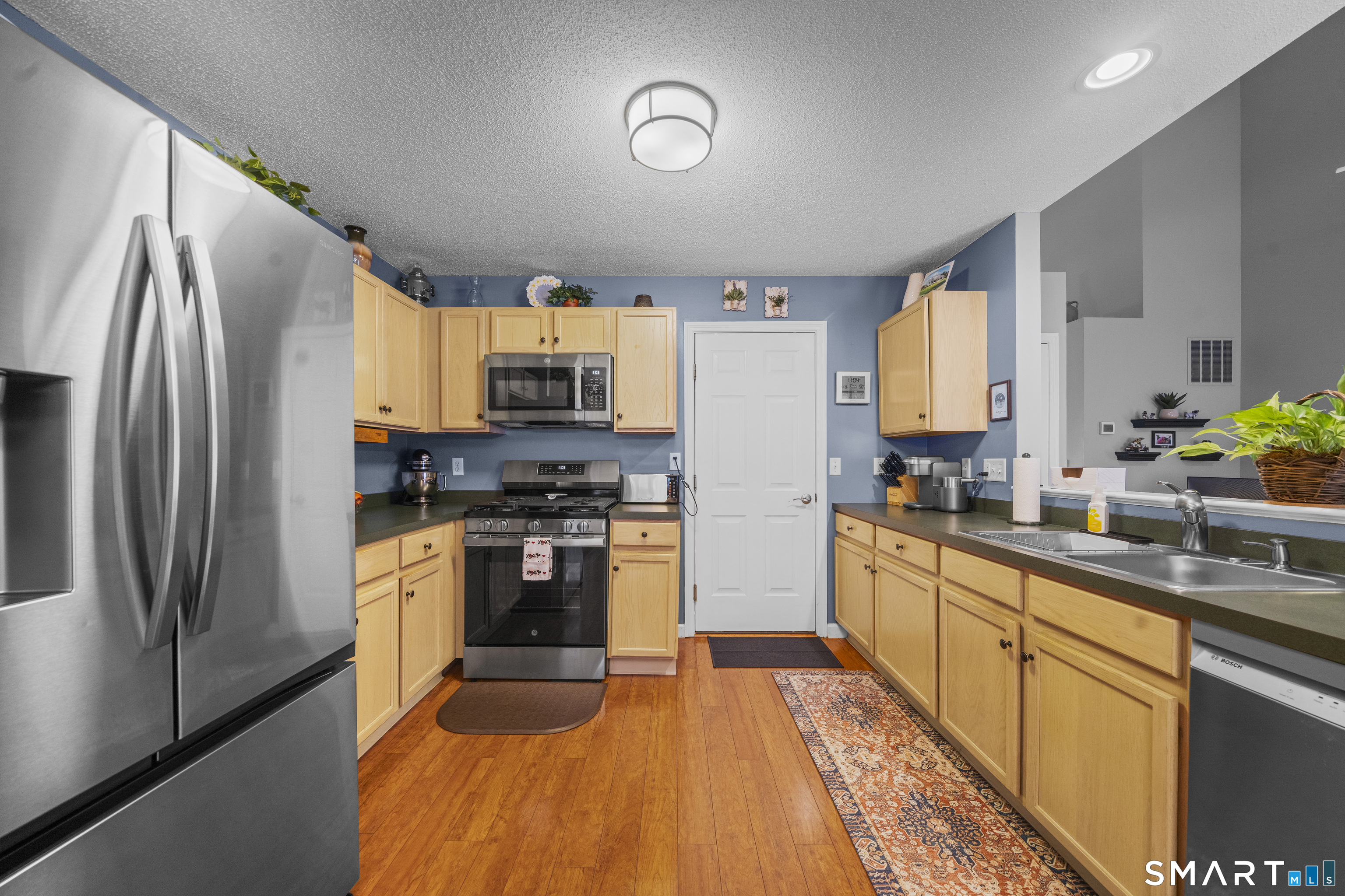 7 Heather Lane, Unit 7 Suffield, CT 06078 - Photo 11 of 34 a kitchen with stainless steel appliances a refrigerator sink and microwave