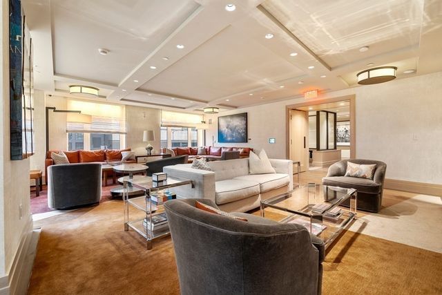 a living room with lots of furniture and a view of kitchen