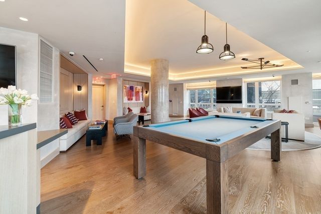 a view of a room with furniture and wooden floor