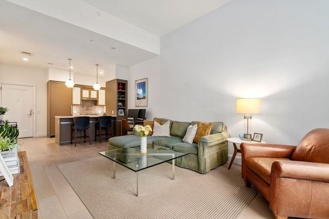 a living room with furniture and a lamp