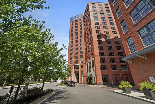 a view of a brick building with a tree in front of it