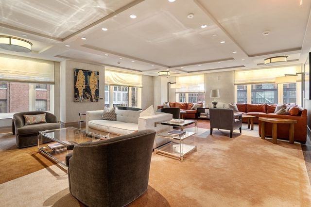 a living room with lots of furniture and a large window