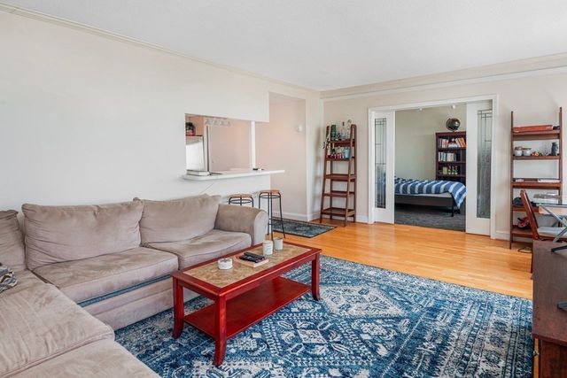 a living room with furniture and a book shelf