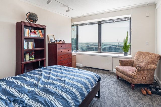 a bedroom with a bed and a large window
